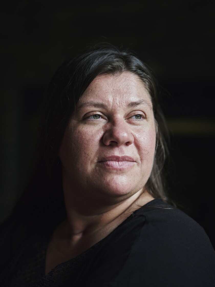 Devon Mitchell, 43, of Kingston, Tenn., poses for a portrait at her home . Mitchell works full-time at DWK Life Sciences as a production associate while attending Roane State Community College, where she is studying business and accounting.   William DeShazer for The Chronicle