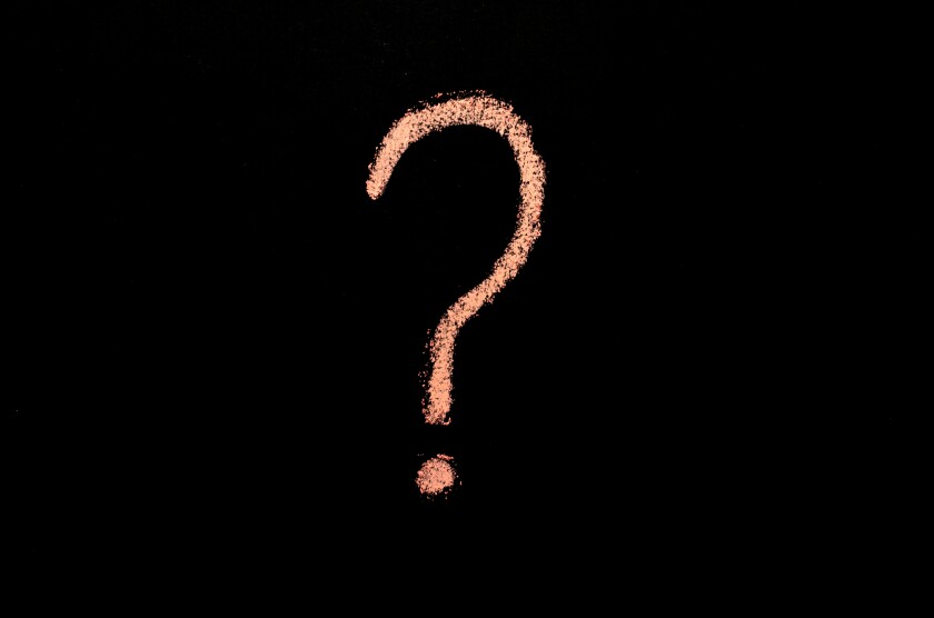 pink question mark on blackboard