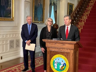 North Carolina Gov. Roy Cooper speaks while former University of North Carolina system presidents Tom Ross, left, and Margaret Spellings listen at a news conference at the Executive Mansion in Raleigh, N.C., on Tuesday, Nov. 1, 2022. Cooper announced that Ross and Spellings would co-chair a Commission on the Future of Public Universities that would look in part and changing the governing structure of the university system and its 17 member schools. (Gary D. Robertson, AP)