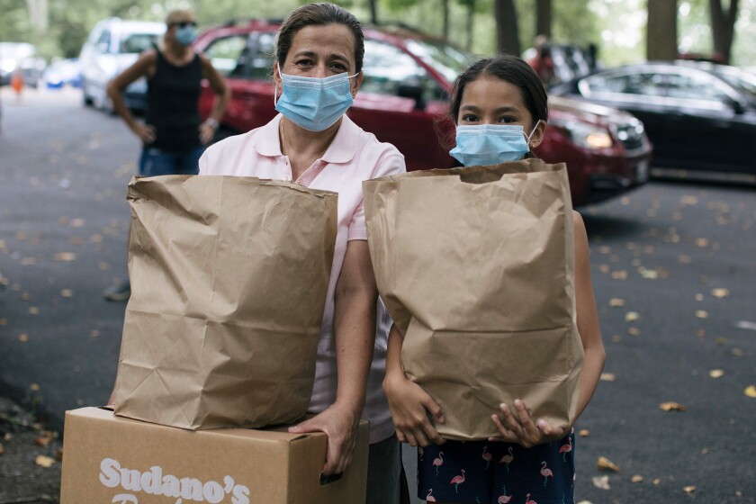 Photo of a woman and child getting groceries