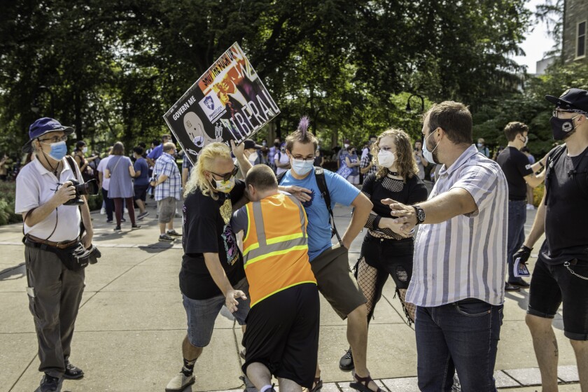 Rachlin, the student Otis Williams (black shirt), and a third demonstrator make contact.