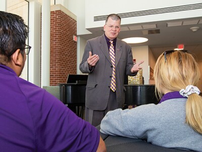 Dan Gerlach, interim chancellor of East Carolina U., talks with students at the student center on its main campus.