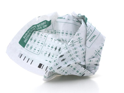 Photo illustration showing a crumpled-up standardized test form.