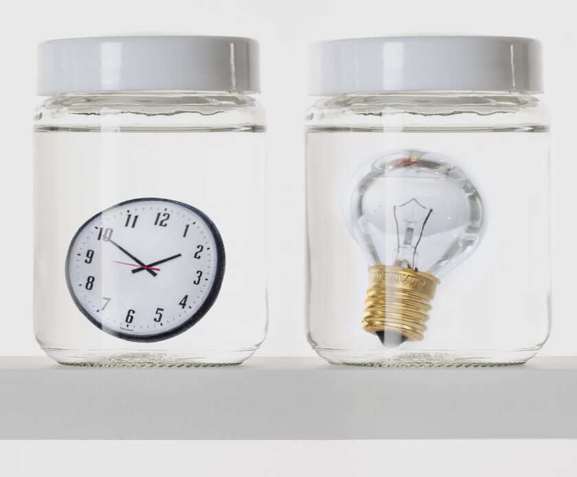 Illustration showing a shelf of lab specimen jars containing a clock and a lightbulb.