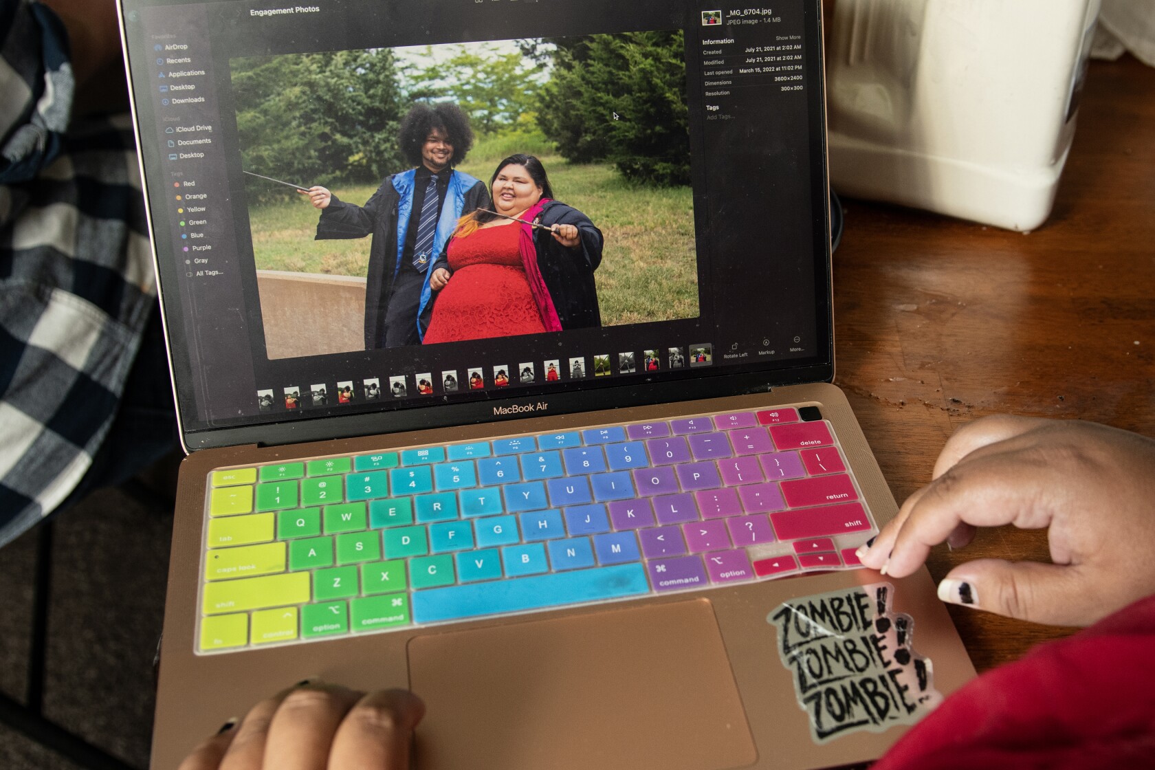 Alicia Gangone looks at a photo of her husband Jaryd Porter (from left) Gangone from their wedding day in her apartment on Tuesday July 17, 2023 in Wichita, Kansas.