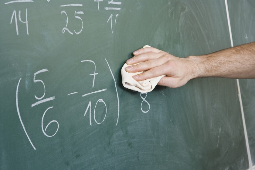 Detail of a man dusting a blackboard - stock photo
