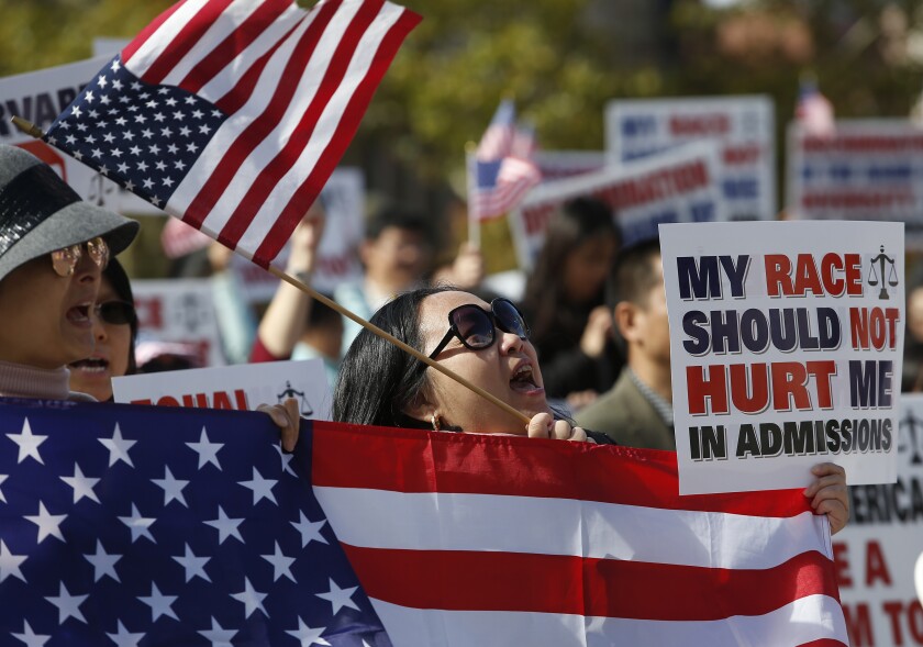 Protesters gather outside a Boston courthouse in support of Students for Fair Admissions’ lawsuit against Harvard. The same group has refiled a lawsuit against the U. of Texas at Austin.