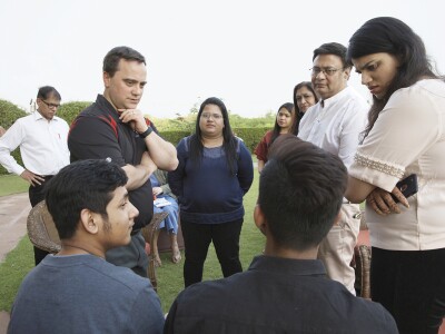 Jonathan Weller (left, in black) speaks with students and parents in India.