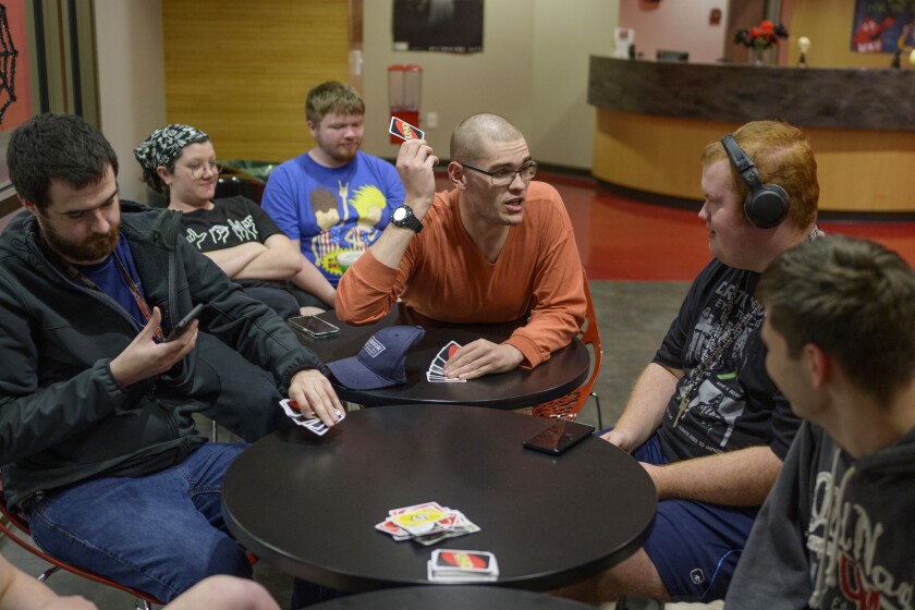 Bowling Green, Ky., - Otto Lewis, 22, middle, takes his turn at Uno while playing with other students in Western Kentucky University’s Kelly Autism Program during a weekly game night at Downing Student Union building on campus. All of the participants are part of Western Kentucky University’s Kelly Autism Program.