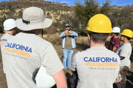 California Climate Action Corps Fellows and volunteers at a Community Climate Action Day learn how to remove deep-rooted, invasive plant species as they begin a habitat restoration and wildfire reduction project.