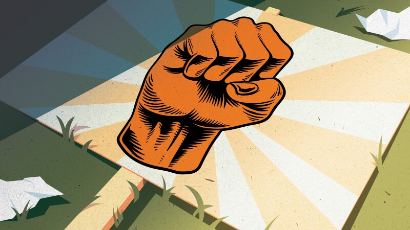 Vector-based illustration of a sign emblazoned with a reddish orange clenched fist layng on the ground