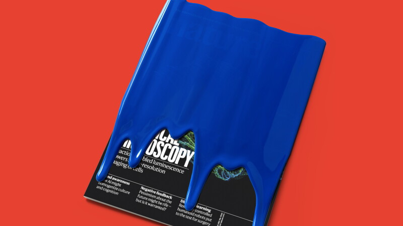 Photo-based illustration of a magazine covered in blue paint against a red background.