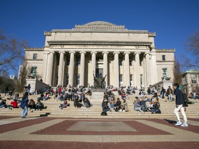 Students sit on the front steps of Low Memorial Library on the Columbia University campus in New York City.