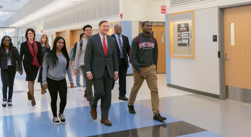 At Stony Brook University, a committed campus community, led by President Samuel L. Stanley Jr. (front) and faculty and staff like Provost’s Scholar for Diversity and Innovation David Ferguson and Career Center Director Marianna Savoca (also pictured), is helping economically disadvantaged students move up the socioeconomic ladder.