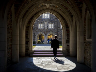 People walk through buildings on the campus of Duke University in Durham, North Carolina.