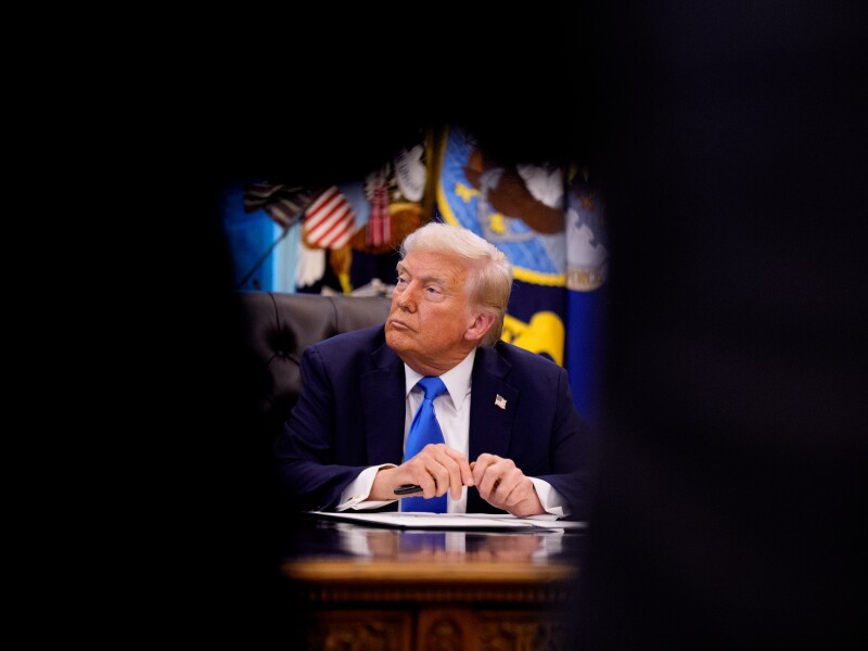 President Donald Trump sits at the Resolute desk after signing an executive order in the Oval Office at the White House on September 19, 2025 in Washington, DC.