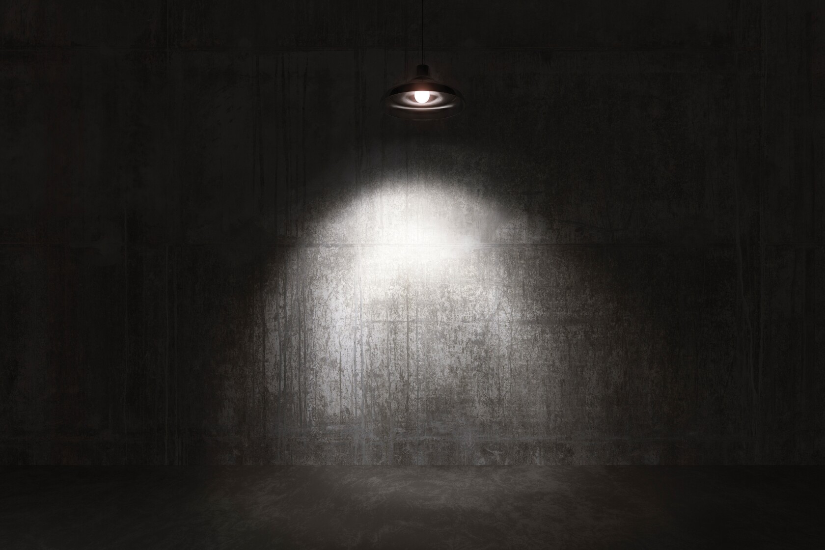 A spotlight on a bare concrete wall in an interrogation room
