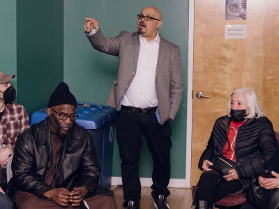 Carmelo Ortiz (center) leads a support group for formerly incarcerated students. Through the prison education program that he himself graduated from, Ortiz won a scholarship and a spot in the honors dorm at Rutgers University at Newark.