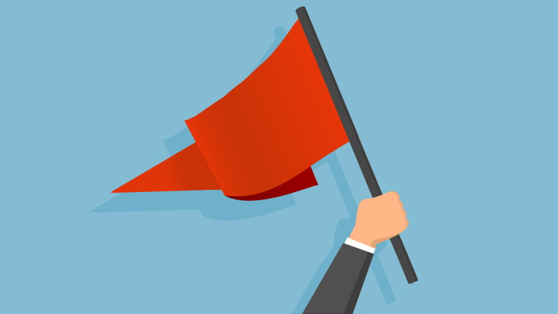 Illustration showing an arm in a business shit waving a large red pennant over a blue background